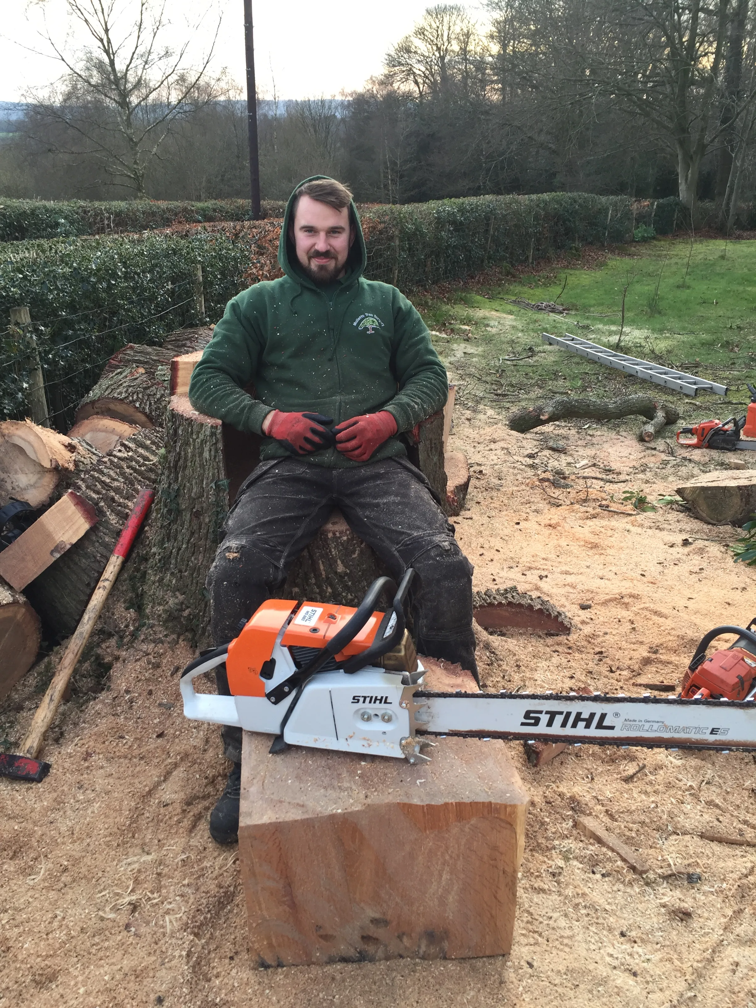 A photo of Josh creating a chair out of a recent dismantled Oak stump 